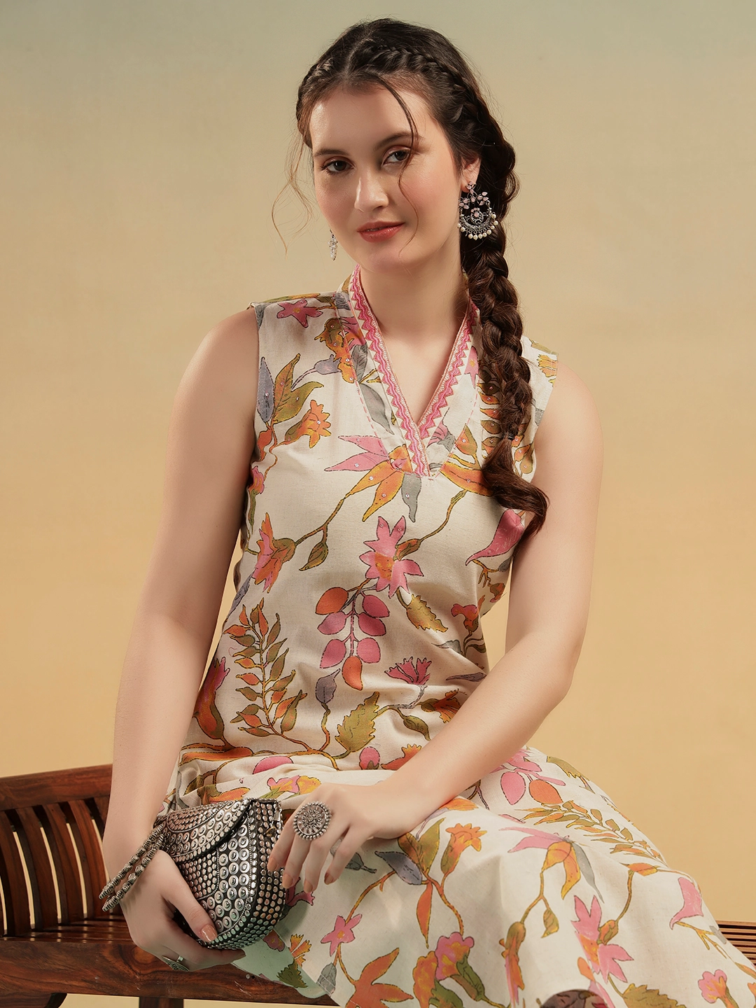 Close-up of floral print neckline with embroidery detail on cream cotton kurti