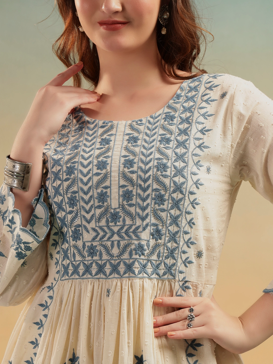 Close-up embroidery detailing on cream cotton A-line kurti