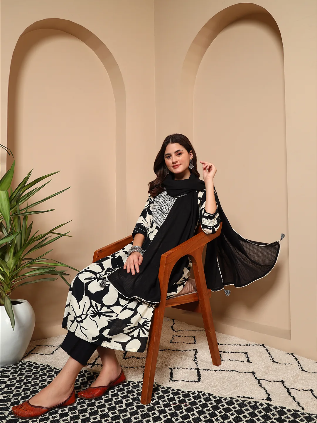 Women seated wearing black floral cotton 3 piece suit se