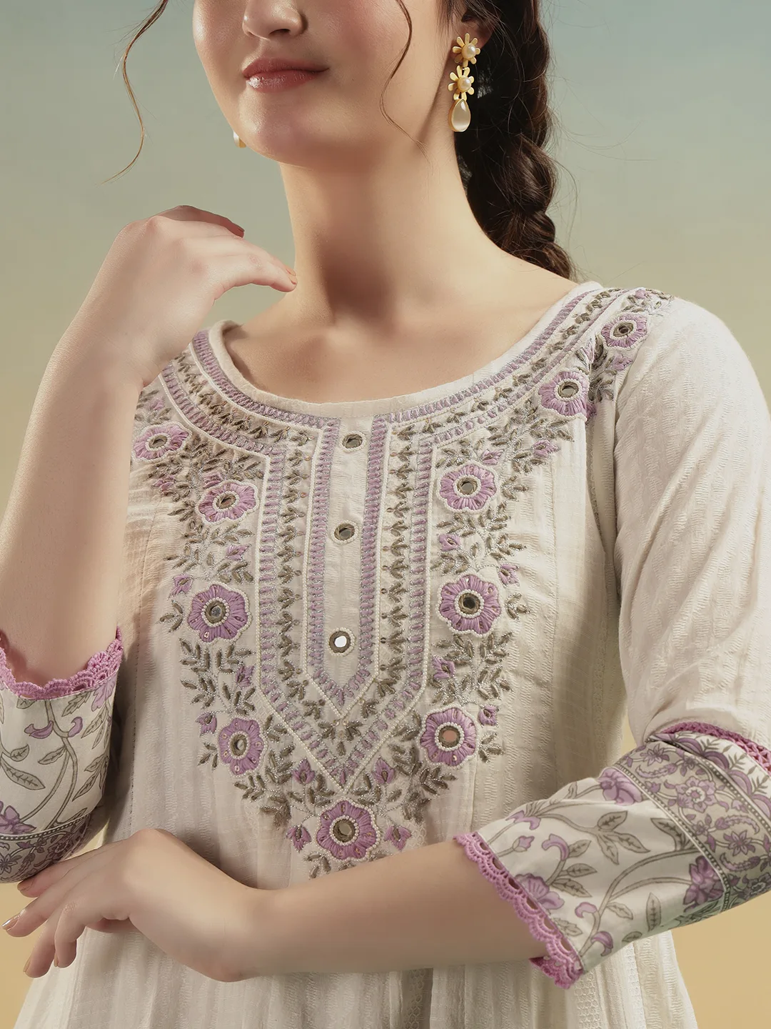 Closeup embroidery neckline detail on ivory cotton dress