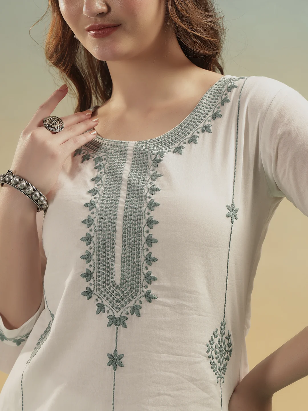Close-up embroidery design on cream cotton kurti neckline